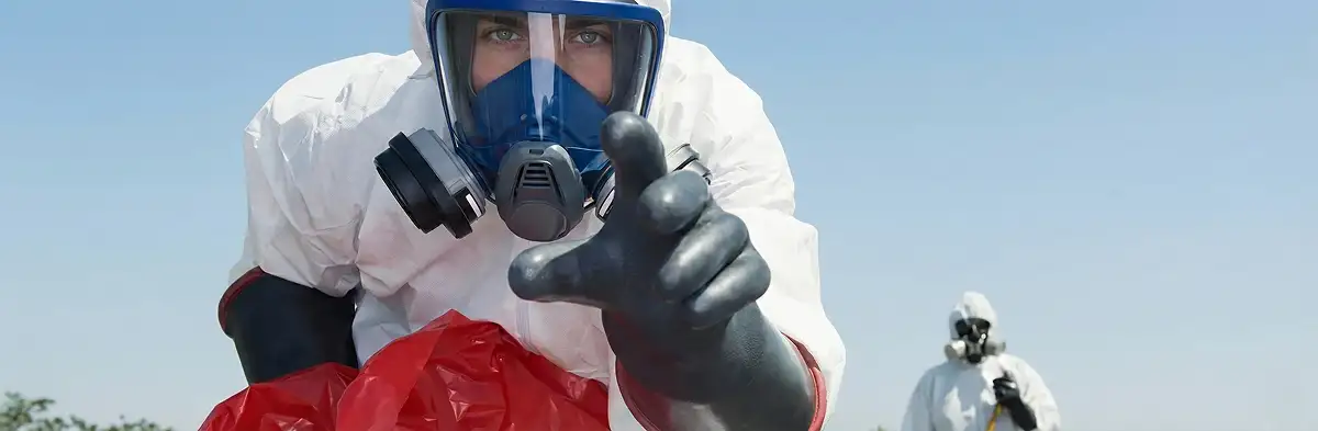 sewage clean up technician wearing protective gear handling biohazard materials in Staten Island, NY