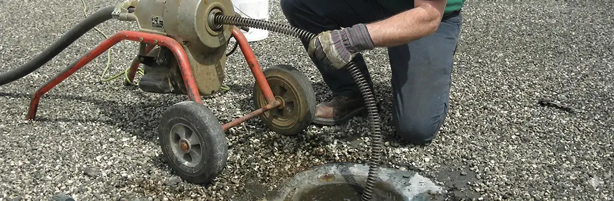 sewer rodding technician actively removing blockages from a sewer line in Staten Island, NY