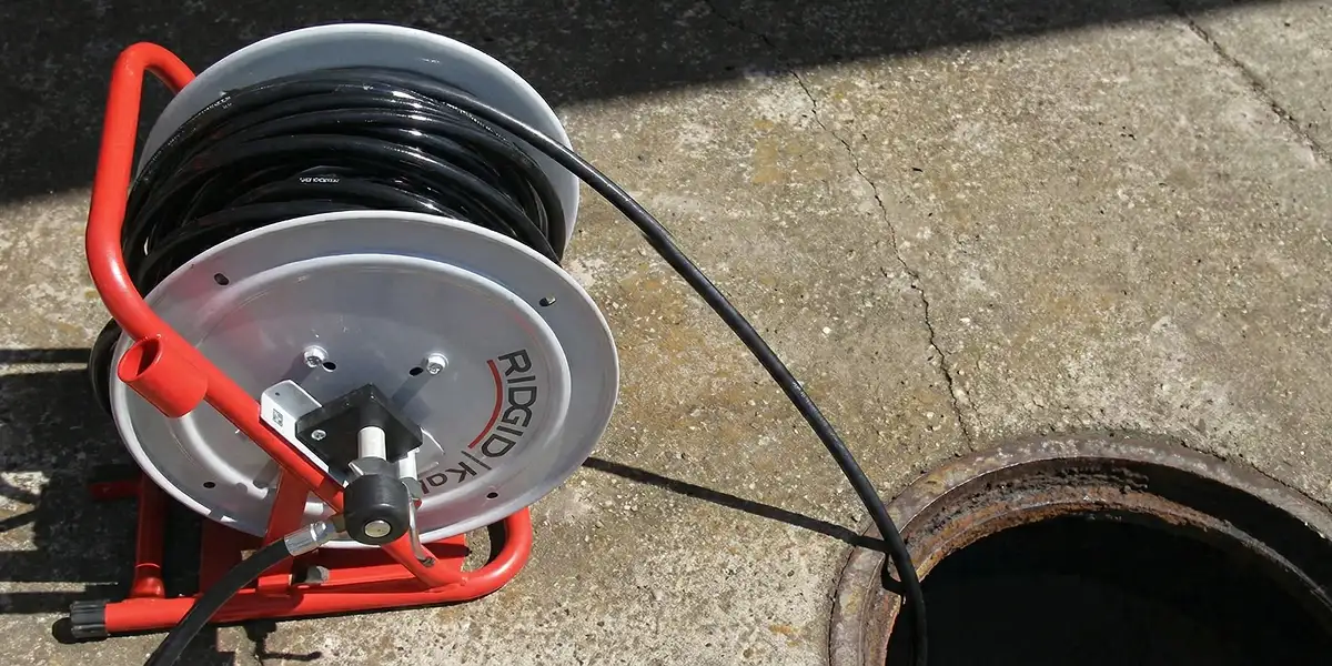 sewer rodding equipment prepared to clear clogged sewer lines in Staten Island, NY